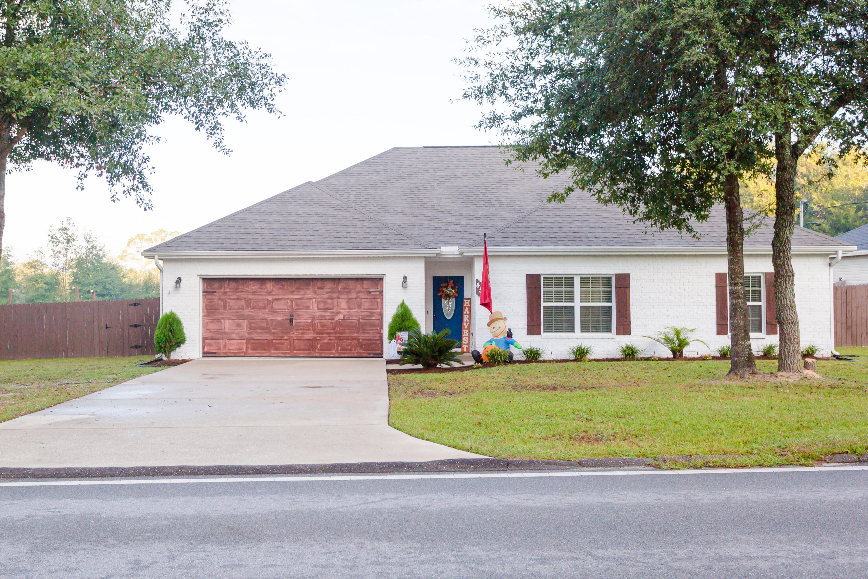 4544 Live Oak Church Road Crestview, FL 32539 - Photo 2 of 31 a front view of a house with a yard and garage