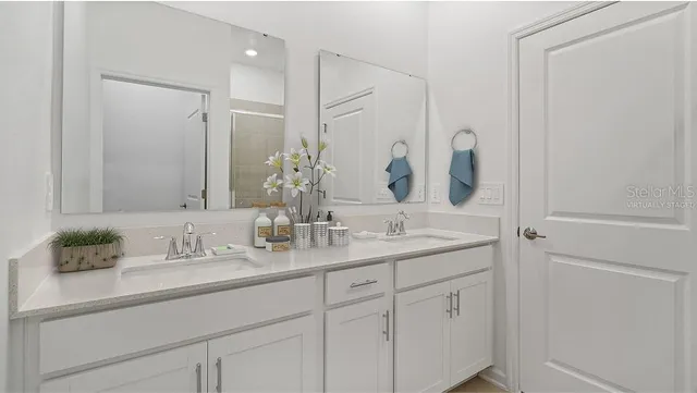 a bathroom with a double vanity sink and mirror