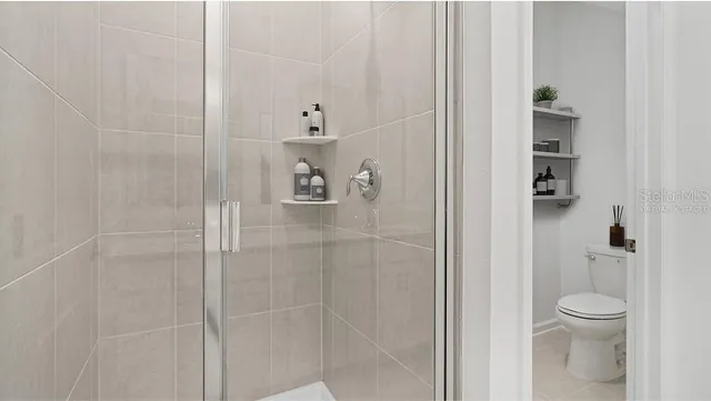 a bathroom with a shower and toilet