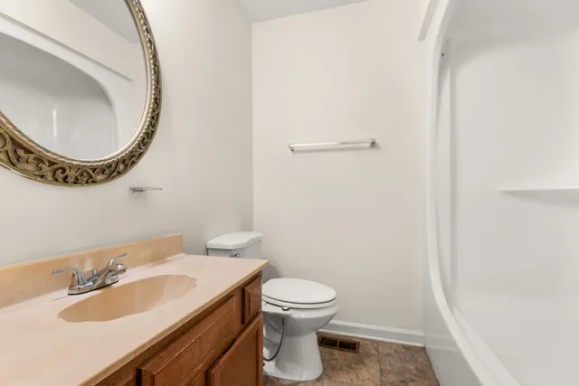 a bathroom with a sink a toilet and a mirror
