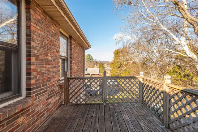 a view of wooden balcony with furniture