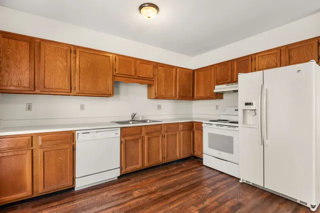 a kitchen with stainless steel appliances granite countertop a stove a sink dishwasher and a refrigerator