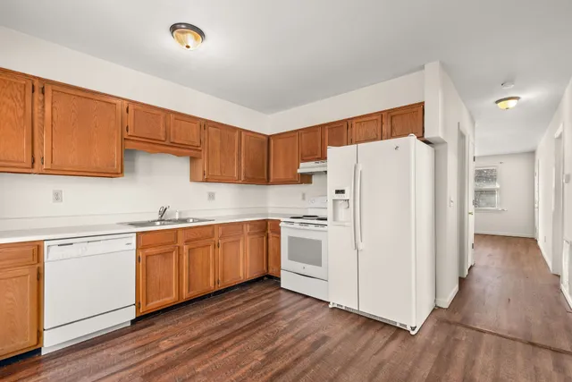 a kitchen with white cabinets and white appliances