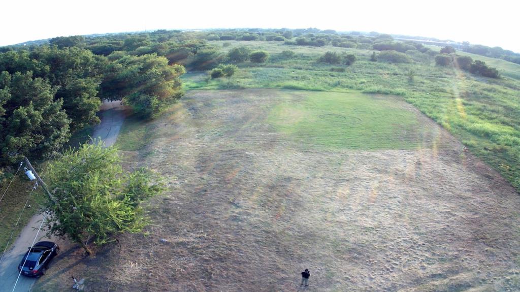 5501 Nomas Street Dallas, TX 75212 - Photo 5 of 10 a view of a field with trees in the background