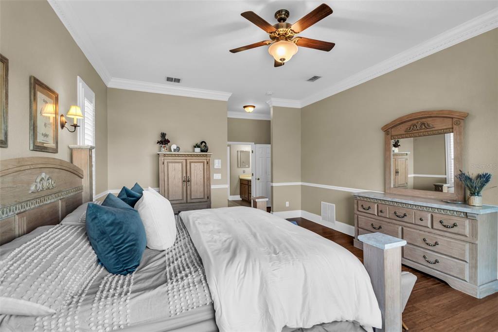 1425 Riviera Drive Kissimmee, FL 34744 - Photo 22 of 82 a bedroom with a large bed and a chandelier