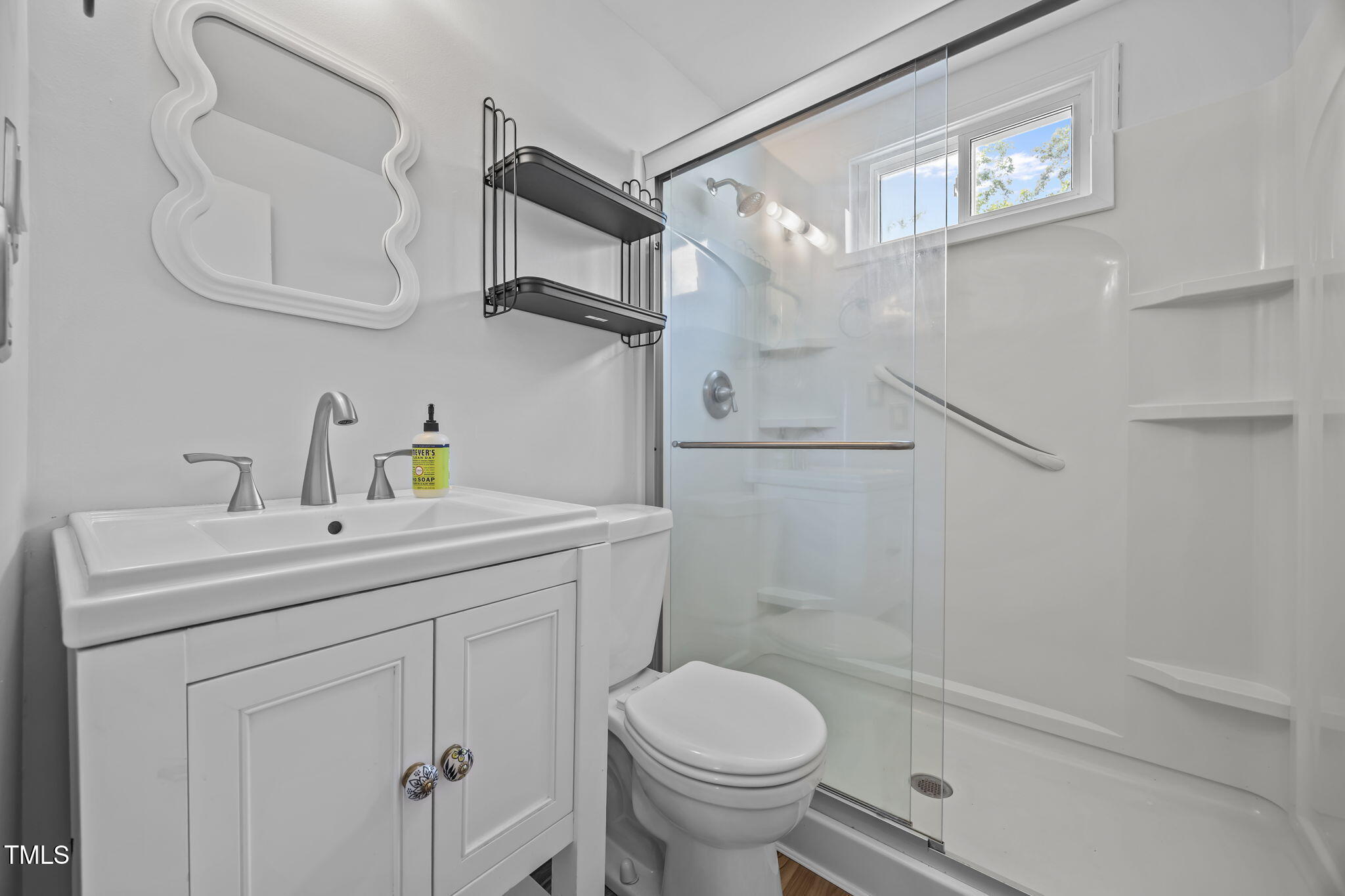 707 Daniels Street, Unit B Raleigh, NC 27605 - Photo 11 of 22 a bathroom with a sink a toilet and shower