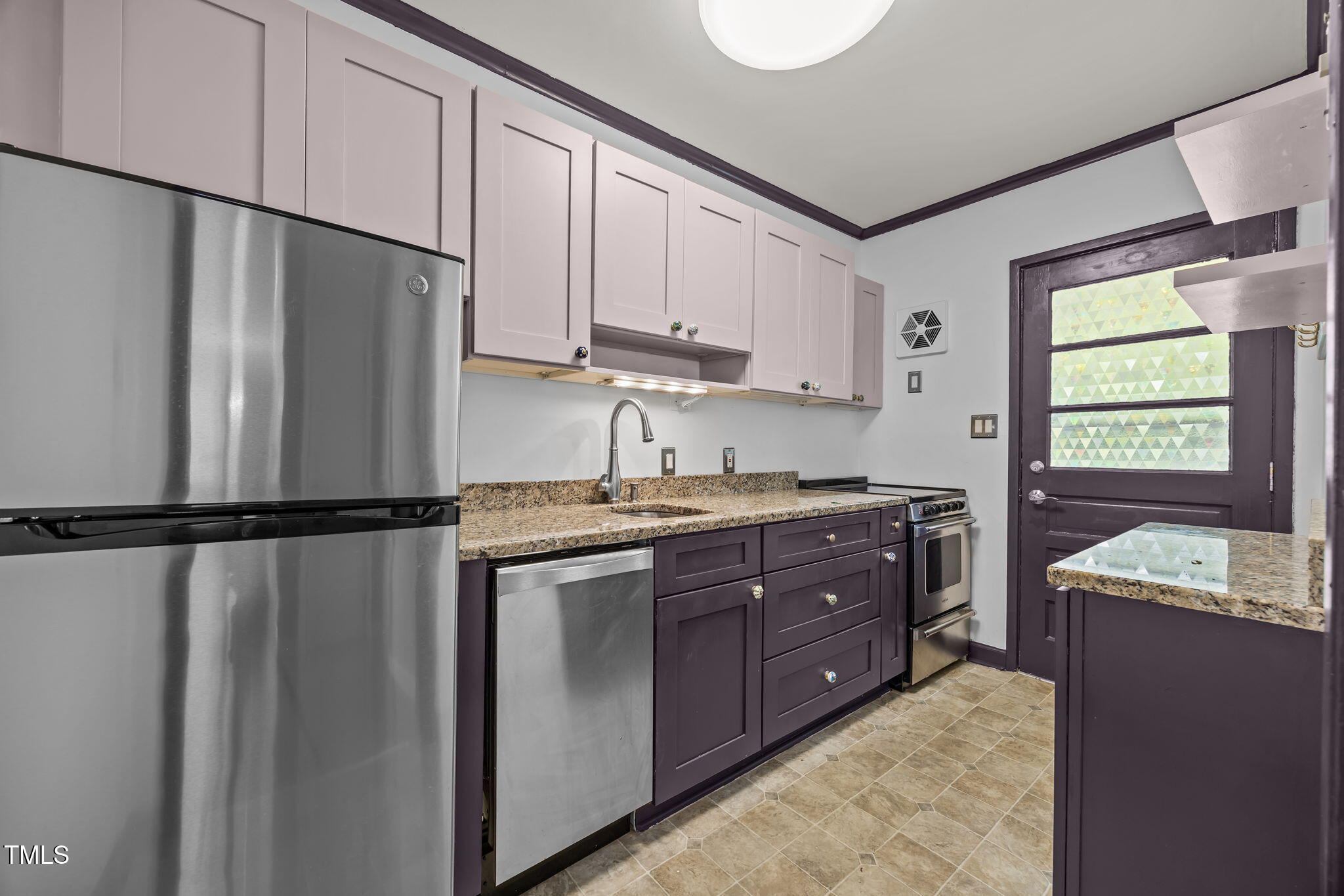 707 Daniels Street, Unit B Raleigh, NC 27605 - Photo 12 of 22 a kitchen with a refrigerator sink and cabinets