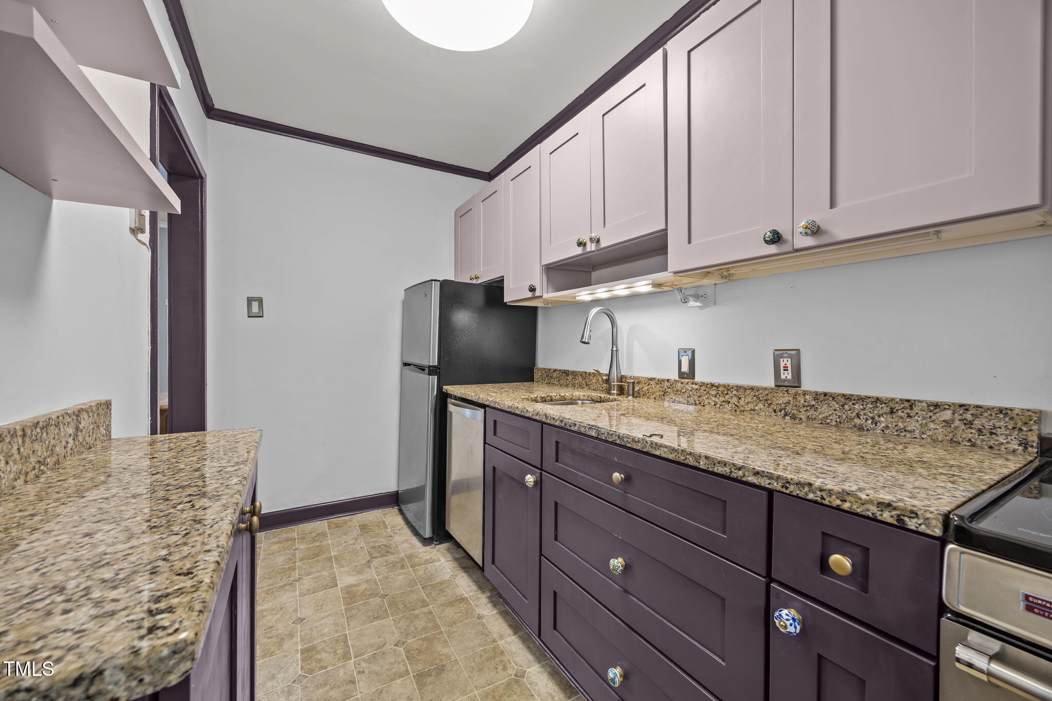 707 Daniels Street, Unit B Raleigh, NC 27605 - Photo 13 of 22 a kitchen with granite countertop cabinets and refrigerator