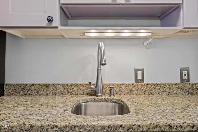 a kitchen with granite countertop counter top space a sink stainless steel appliances and cabinets