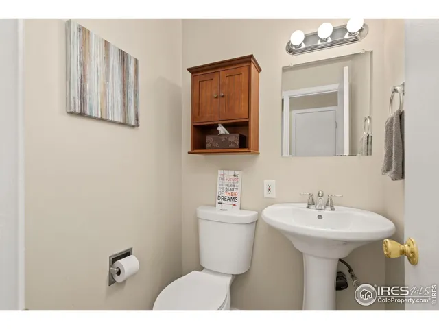 a bathroom with a sink mirror and toilet