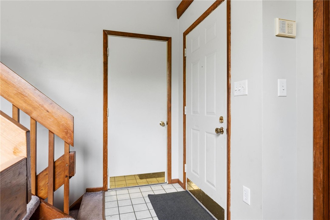 1940 Armstrong Road Fairborn, OH 45324 - Photo 8 of 48 The entryway features practical tile flooring and an inviting staircase, ready to welcome you home.