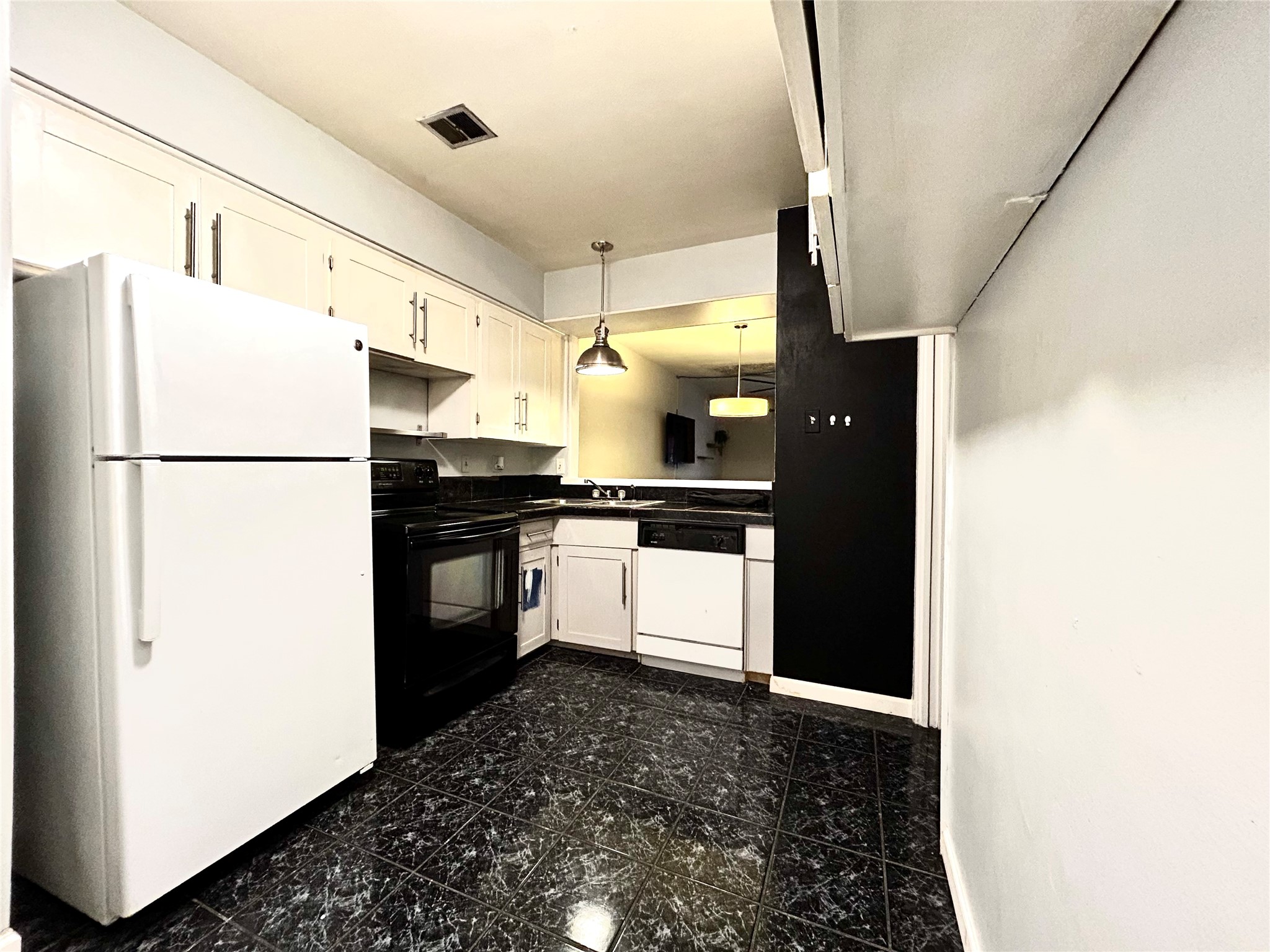 7825 Rue St Cyr Street, Unit 53 Houston, TX 77074 - Photo 2 of 11 a kitchen with a refrigerator and a stove