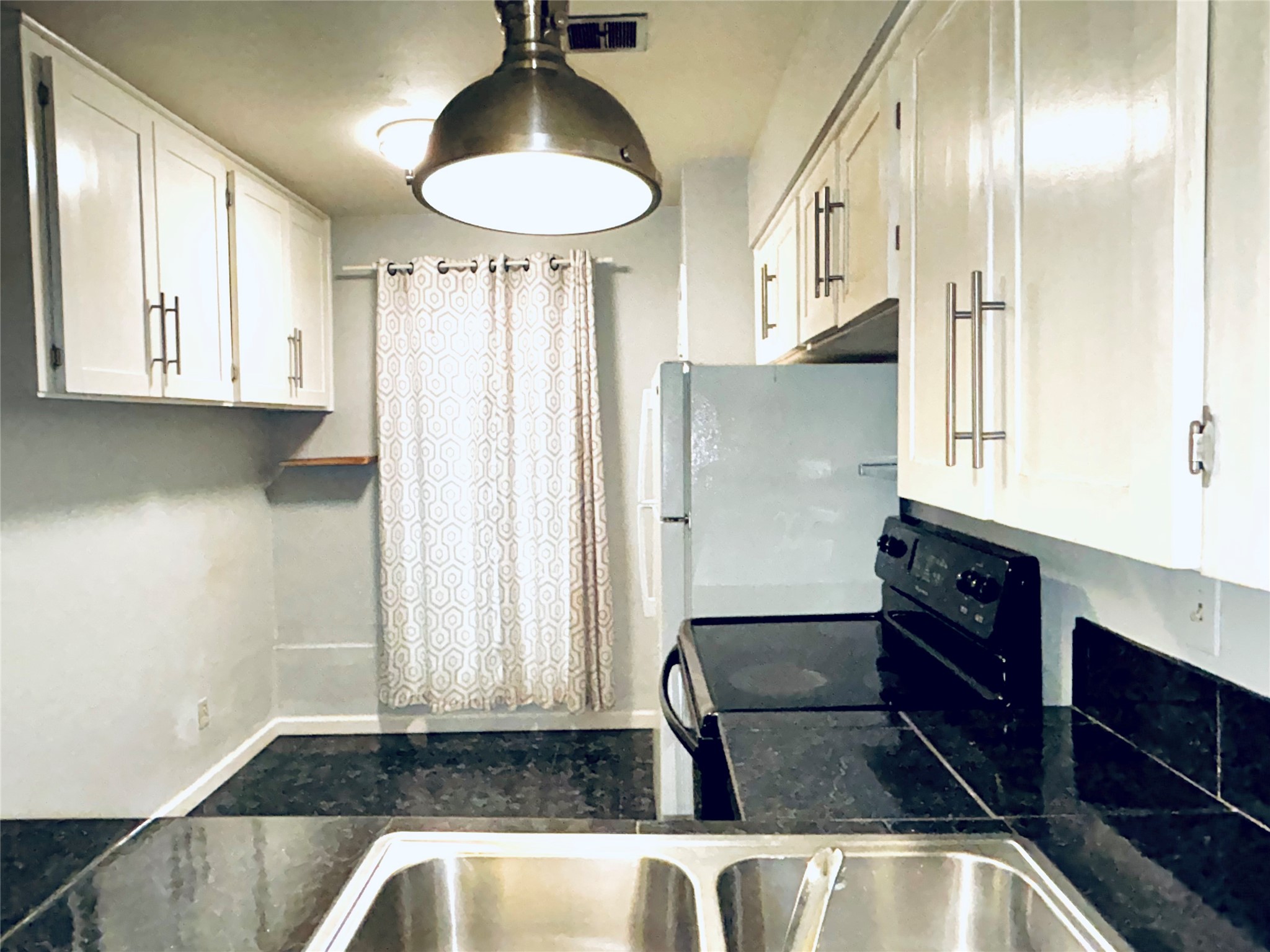 7825 Rue St Cyr Street, Unit 53 Houston, TX 77074 - Photo 3 of 11 a kitchen with stainless steel appliances granite countertop a refrigerator and a sink