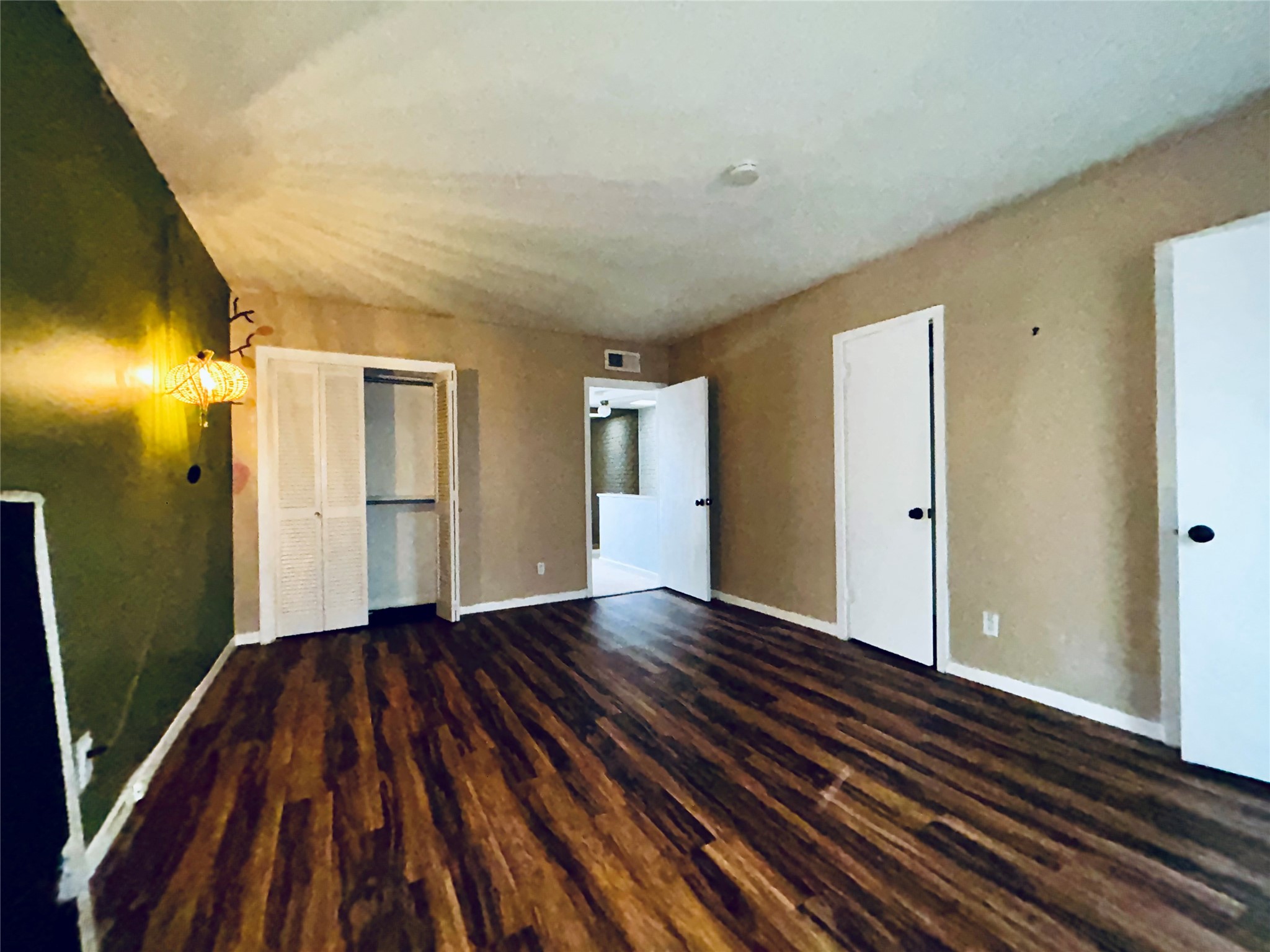 7825 Rue St Cyr Street, Unit 53 Houston, TX 77074 - Photo 7 of 11 a view of an empty room with wooden floor and a bathroom
