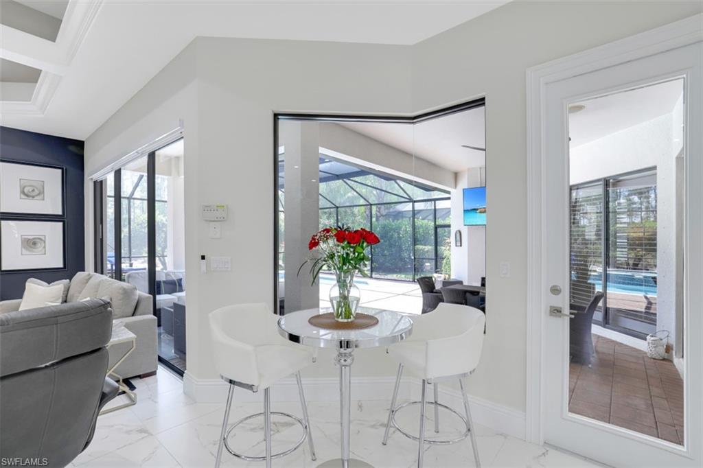 7323 Acorn Way Naples, FL 34119 - Photo 10 of 21 Breakfast nook and light tile flooring