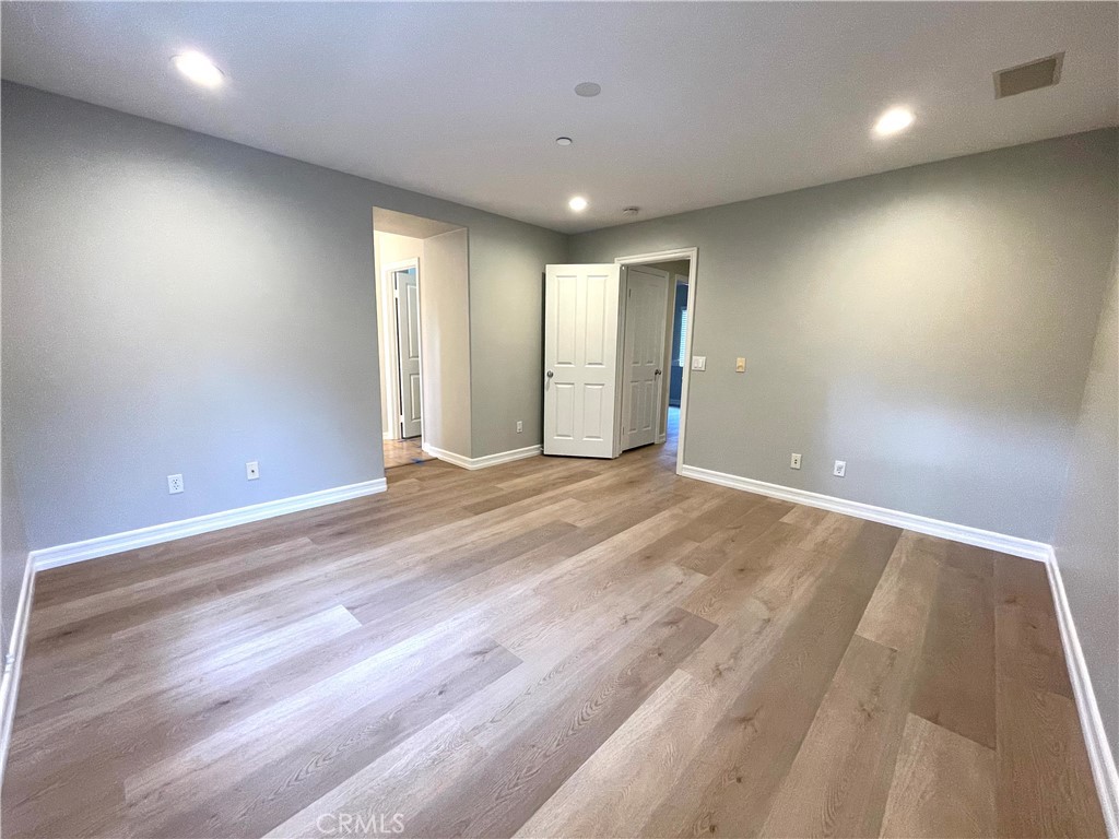 20 Arborside Irvine, CA 92603 - Photo 19 of 36 an empty room with wooden floor and windows
