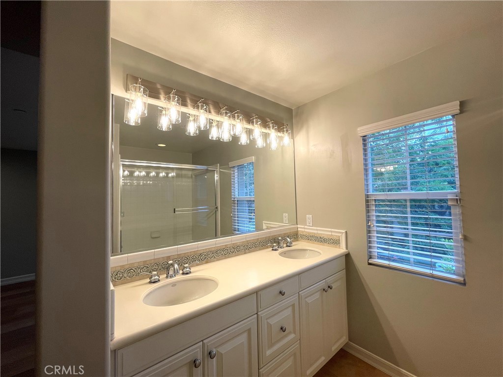 20 Arborside Irvine, CA 92603 - Photo 20 of 36 a bathroom with a double vanity sink and a mirror