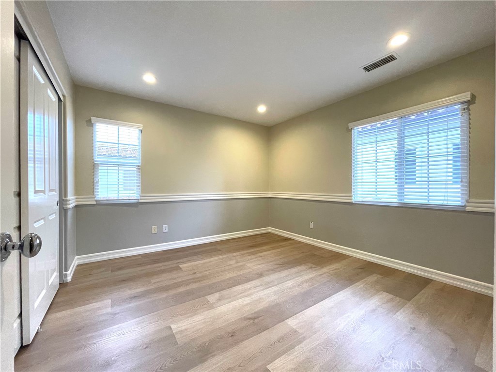 20 Arborside Irvine, CA 92603 - Photo 24 of 36 an empty room with wooden floor and windows