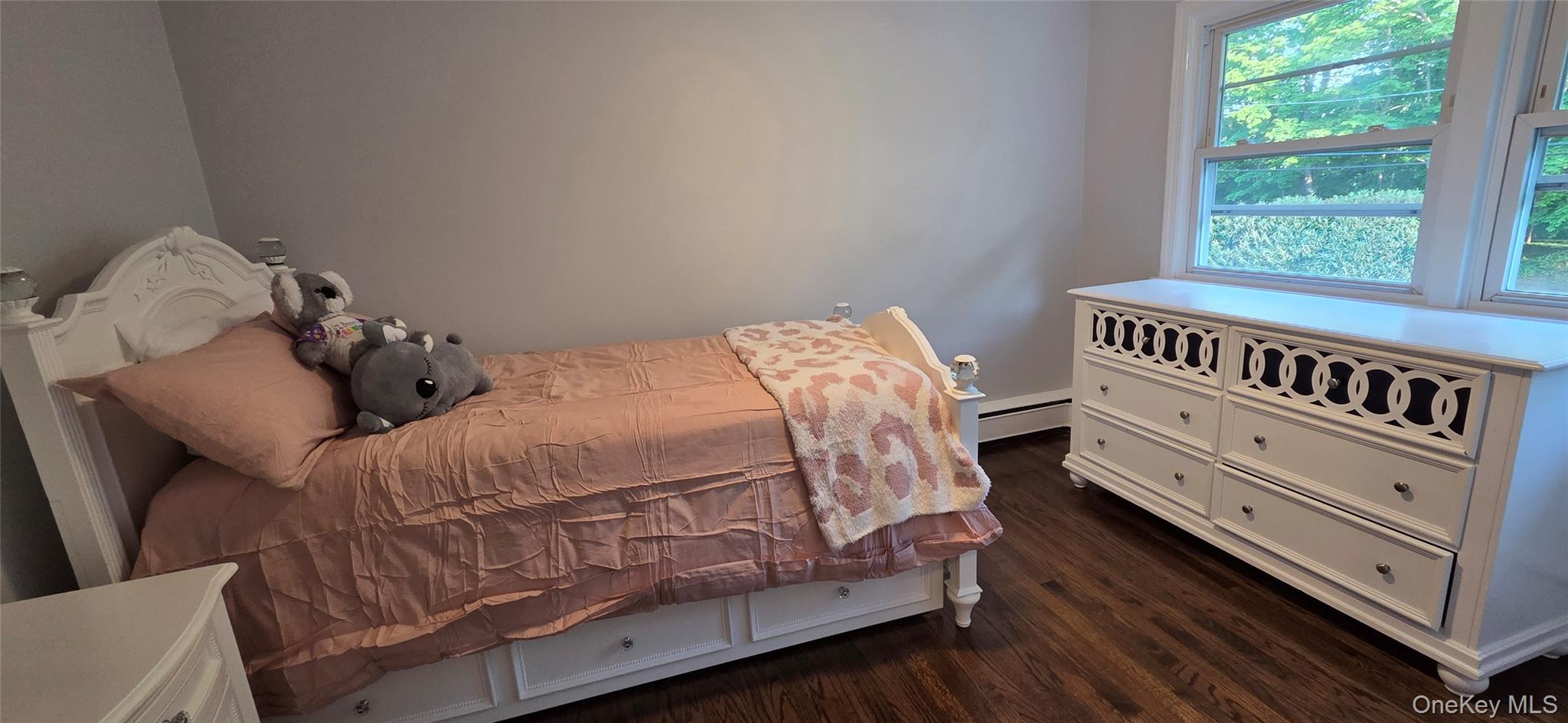 522 Moriches Road St. James, NY 11780 - Photo 25 of 49 a bedroom with a bed and a window