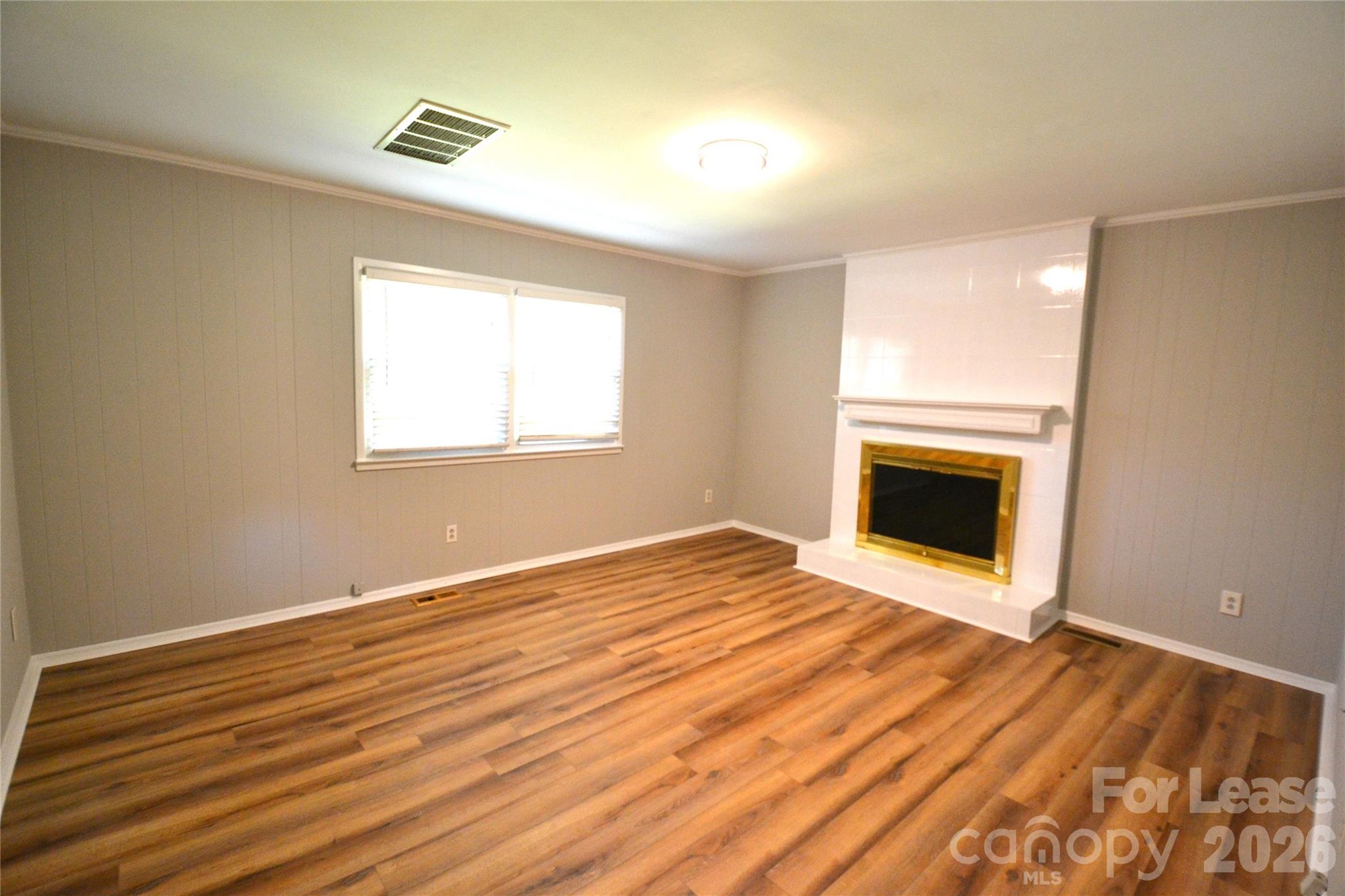 1422 Thermal Road Charlotte, NC 28212 - Photo 8 of 40 a view of empty room with wooden floor and fireplace