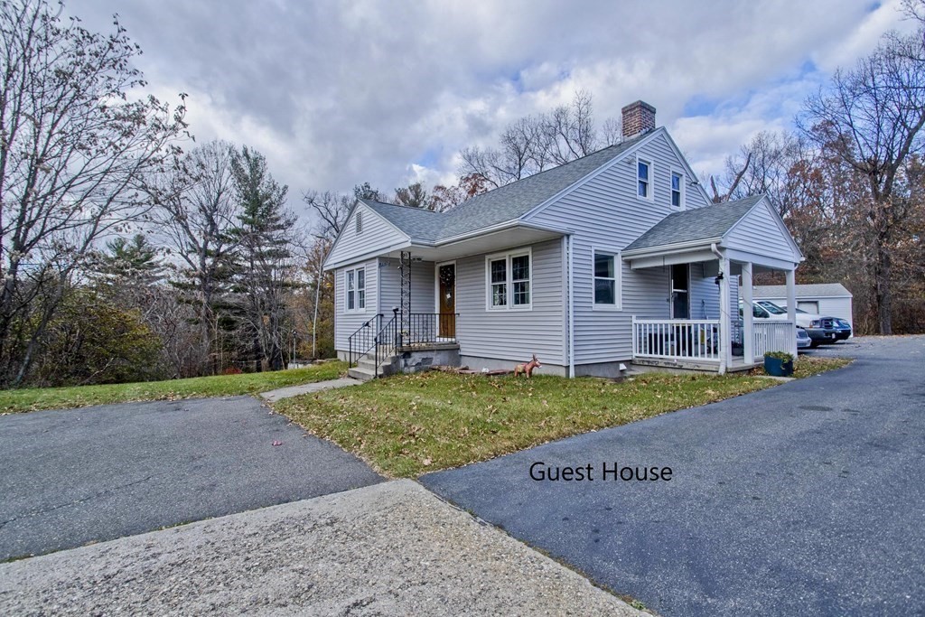 860 Plumtree Road Springfield, MA 01109 - Photo 2 of 21 a front view of a house with a yard and garage