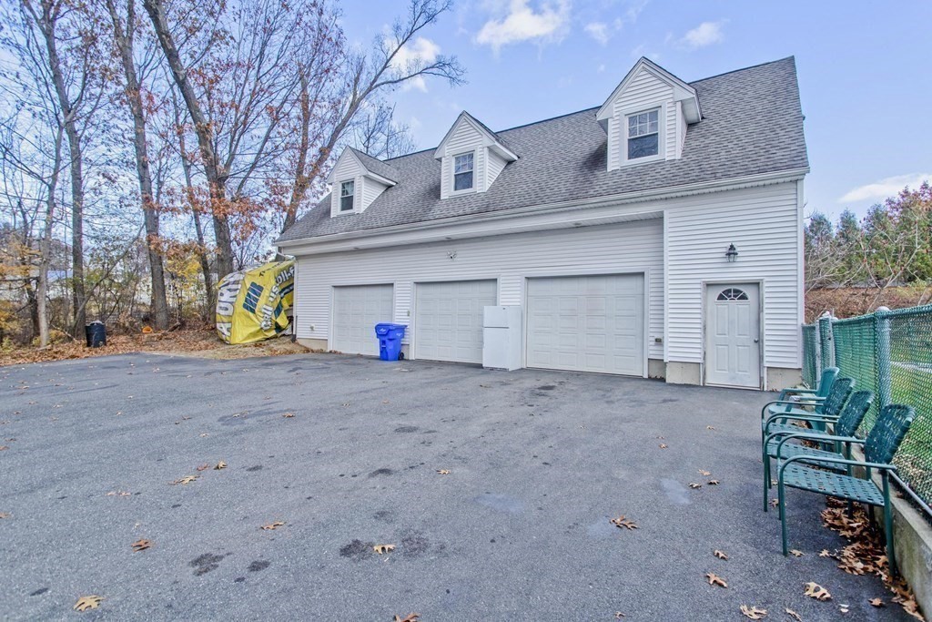 860 Plumtree Road Springfield, MA 01109 - Photo 4 of 21 a view of a house with a yard and garage