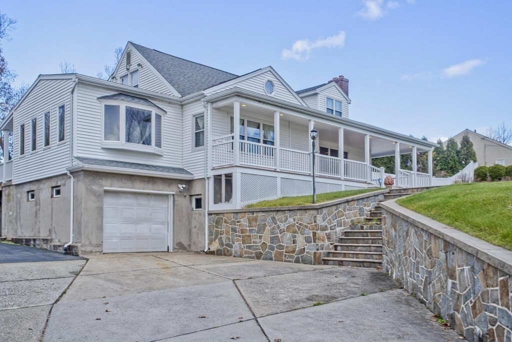 860 Plumtree Road Springfield, MA 01109 - Photo 6 of 21 a front view of a house with a garden and plants