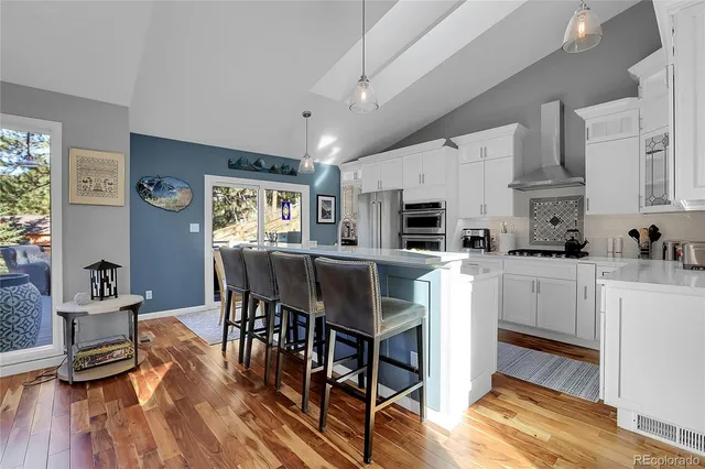 a kitchen with white cabinets and appliances