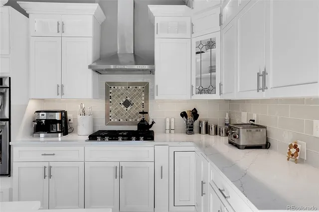 a kitchen with stainless steel appliances a sink a stove and cabinets