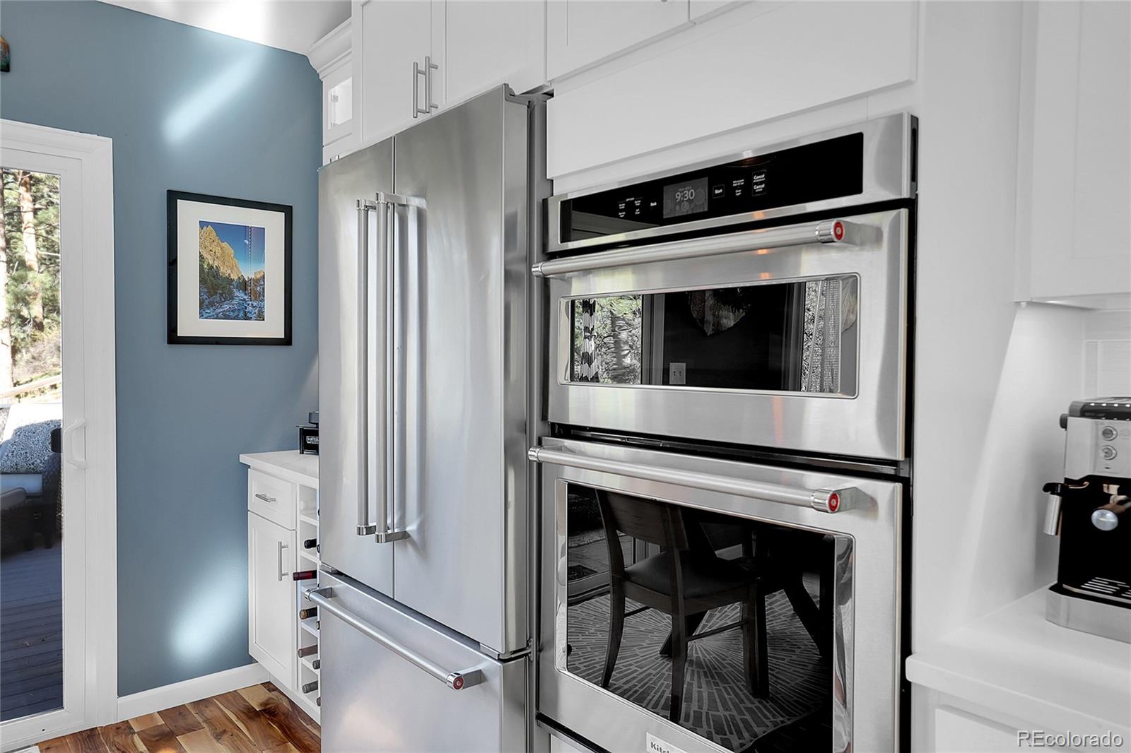 32857 Little Cub Road Evergreen, CO 80439 - Photo 16 of 48 a kitchen with cabinets and stainless steel appliances