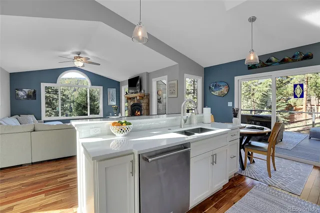 a dining hall with stainless steel appliances granite countertop furniture and a large window