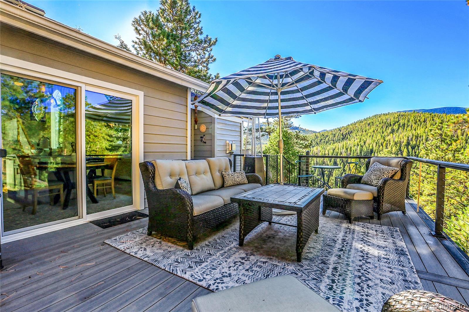 32857 Little Cub Road Evergreen, CO 80439 - Photo 2 of 47 a roof deck with a table and chairs