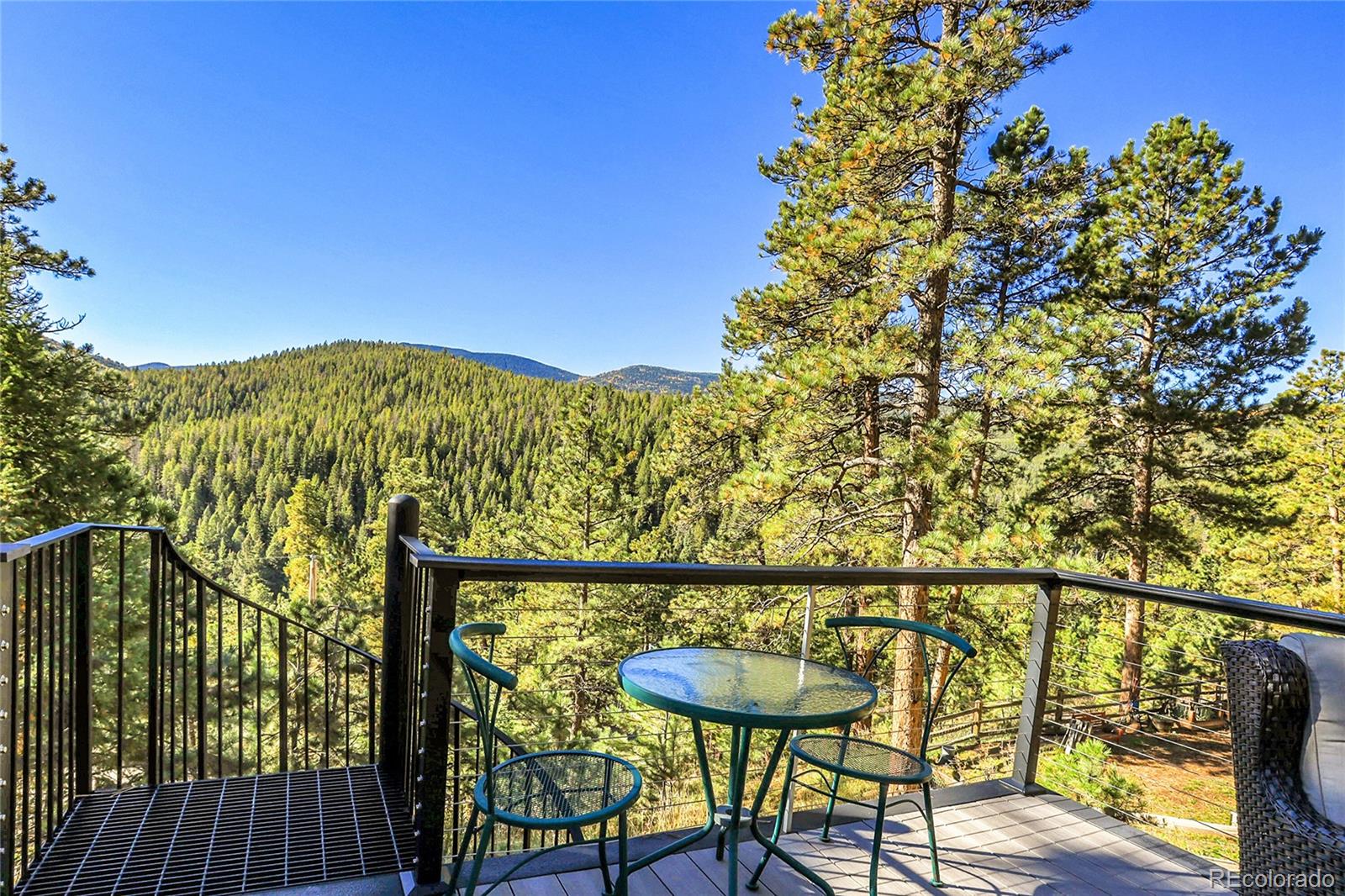 32857 Little Cub Road Evergreen, CO 80439 - Photo 21 of 48 a view of a chairs and table on the wooden floor