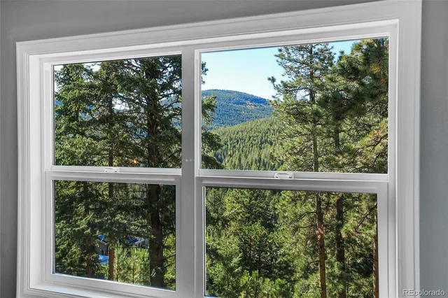 a bedroom with furniture and a large window