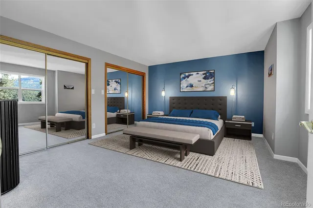 a large bedroom with a bed and a television