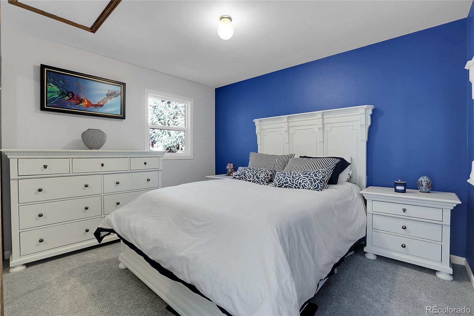 32857 Little Cub Road Evergreen, CO 80439 - Photo 34 of 48 a bedroom with a bed and a dresser