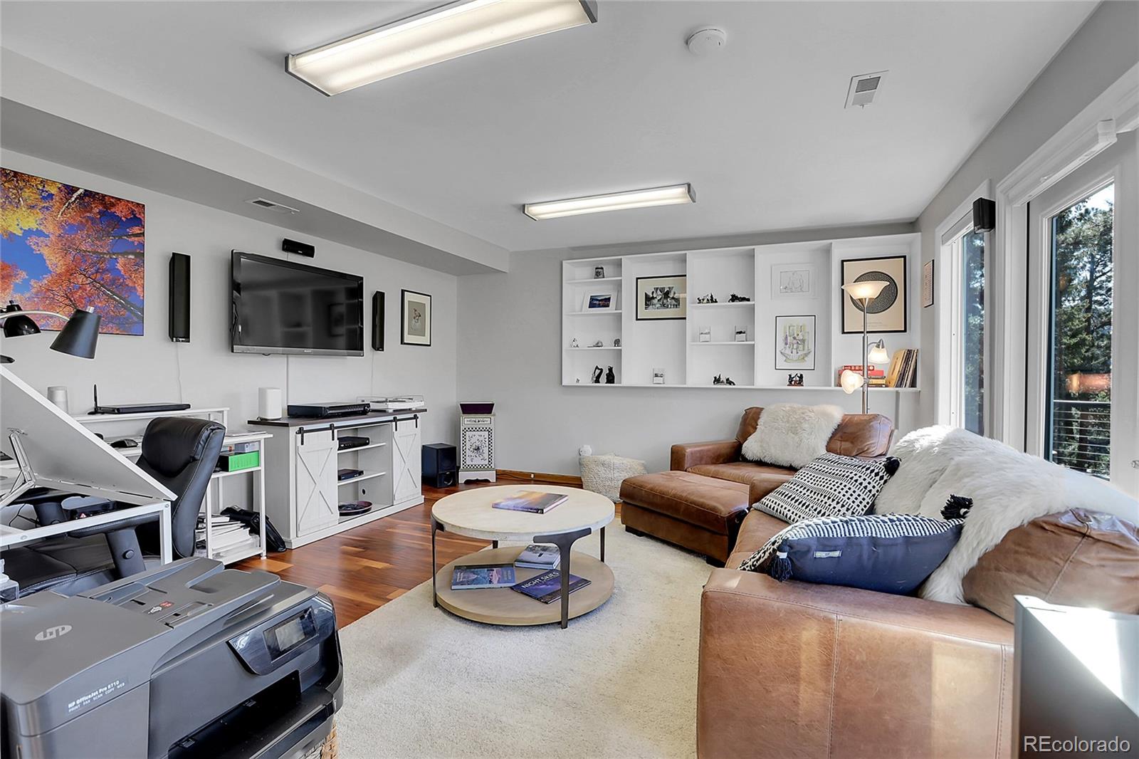 32857 Little Cub Road Evergreen, CO 80439 - Photo 37 of 48 a living room with furniture a flat screen tv and a window