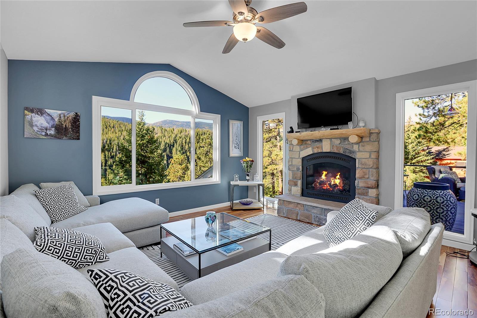 32857 Little Cub Road Evergreen, CO 80439 - Photo 4 of 47 a living room with furniture fireplace and window