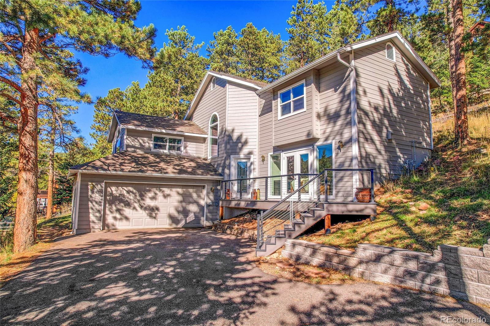 32857 Little Cub Road Evergreen, CO 80439 - Photo 47 of 47 a view of a white house with a large tree tree front of it