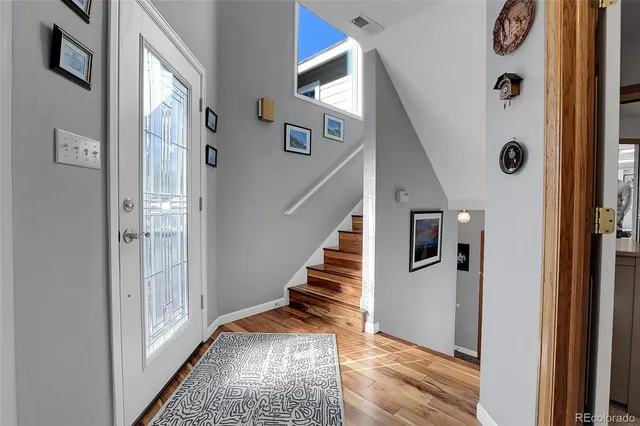 a view of an entryway with wooden floor and stairs