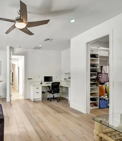 a view of a livingroom with workspace and a window