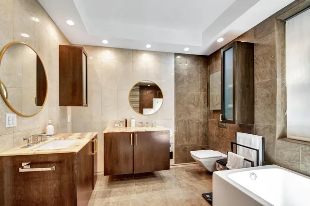 a spacious bathroom with a double vanity sink and a mirror