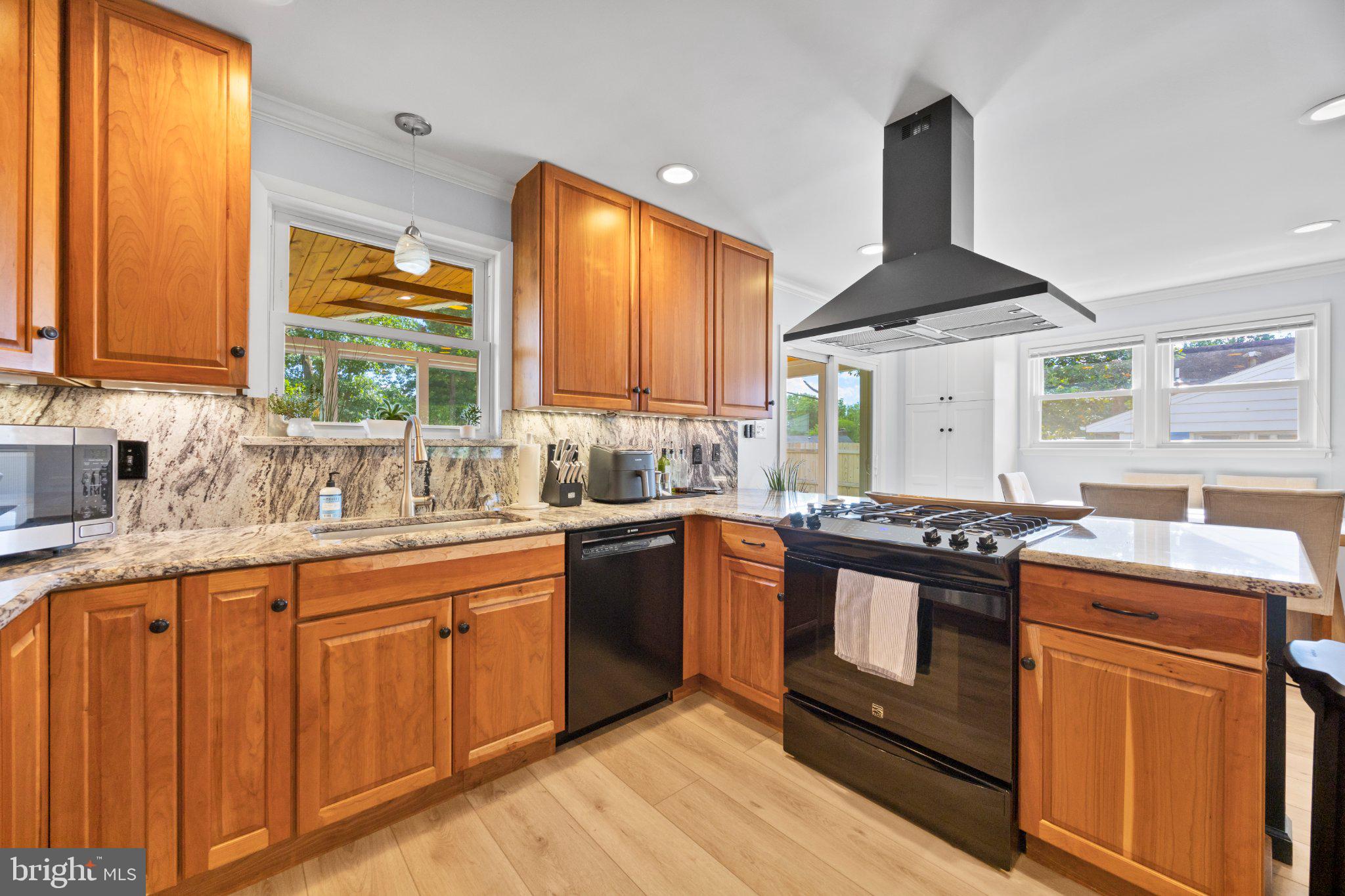6705 New Hope Drive Springfield, VA 22151 - Photo 25 of 67 Modern kitchen with warm wood accents.