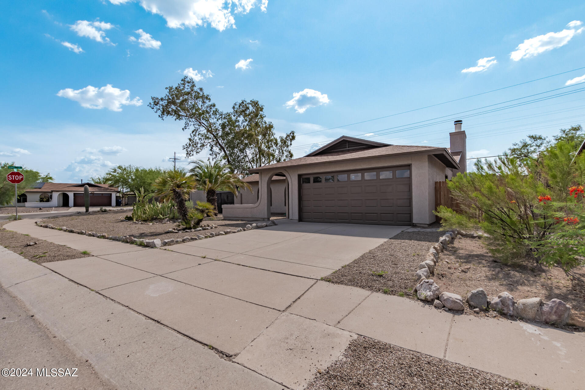 1454 South Gecko Road Tucson, AZ 85713 - Photo 3 of 24 a front view of a house with a yard and garage