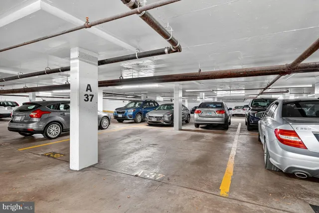 a view of parking garage with cars parked