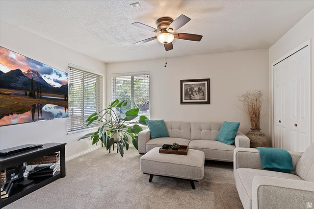 1924 North 2000th Street East Layton, UT 84040 - Photo 19 of 41 Living area with carpet floors, ceiling fan, and a textured ceiling