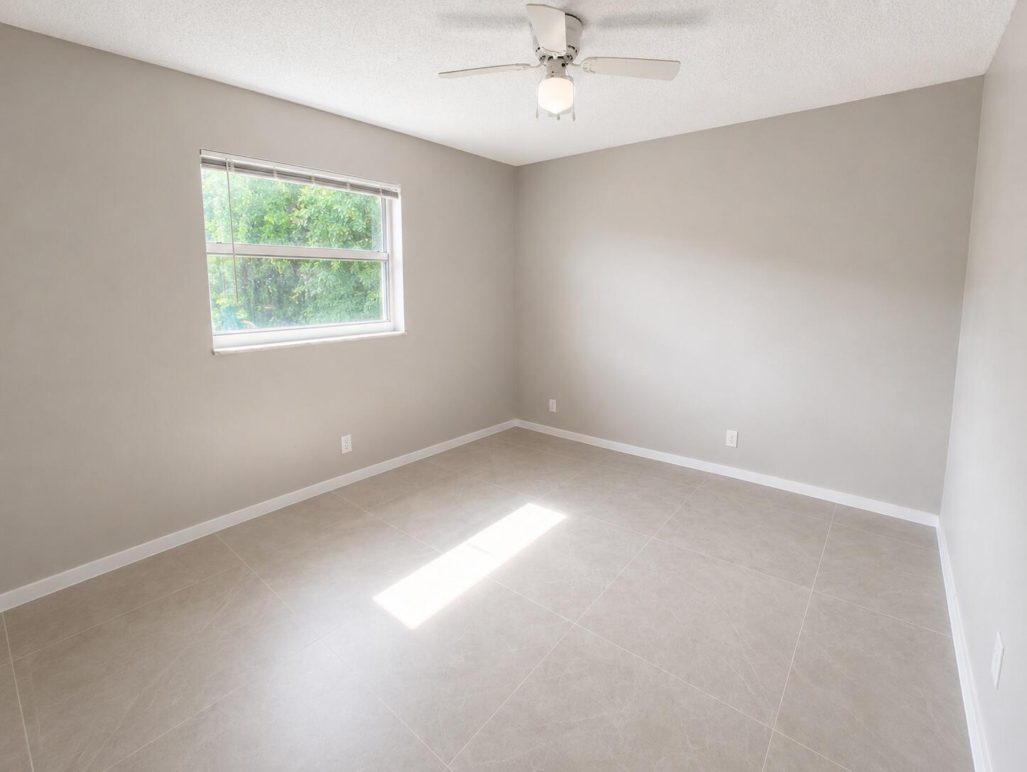 1794 Juno Road, Unit 2 North Palm Beach, FL 33408 - Photo 5 of 9 an empty room with a window