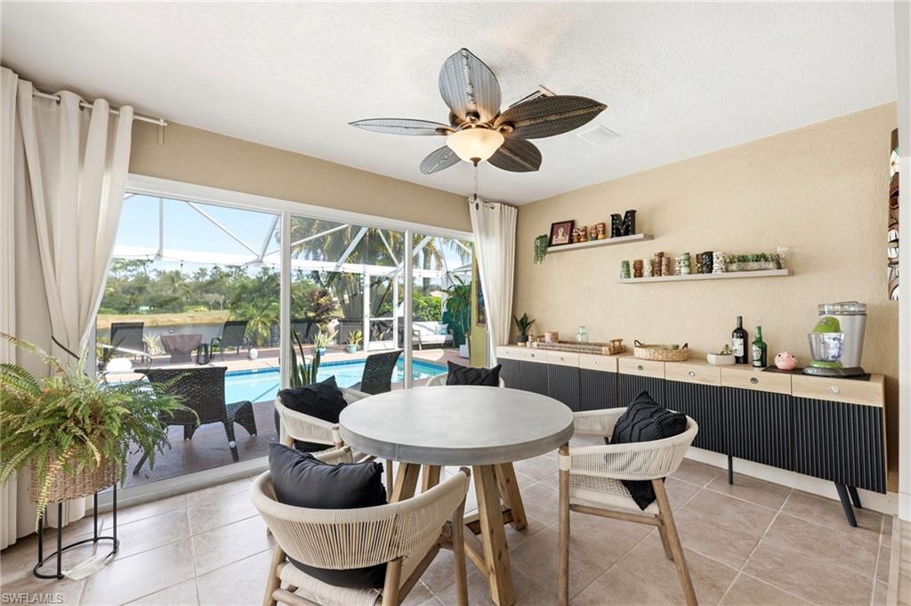 7575 Novara Court Naples, FL 34114 - Photo 24 of 49 Dining area in extended room with access to the pool deck/lanai