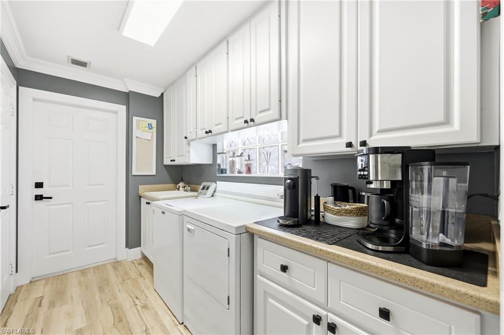 7575 Novara Court Naples, FL 34114 - Photo 29 of 49 Laundry room with Washer/ Dryer, Sink and cabinets