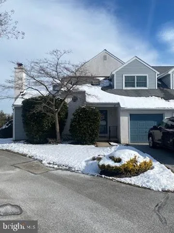 a front view of a house with a yard and parking space